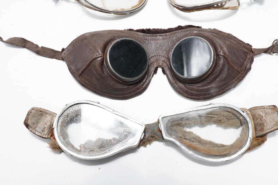 A pair of early aviation aluminium framed flying goggles, a pair of leather and felt lined goggles with green tinted lenses, a pair of French ? aviator flying goggles and a pair of WW2 First Pattern RAF Night Simulation